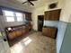 Dilapidated kitchen with wooden cabinets, poor floor, and peeling paint ready to be renovated at 1739 E 18Th St, Anderson, IN 46016