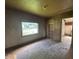 Spacious living room with hardwood floors and a view of the front yard through a large window at 1739 E 18Th St, Anderson, IN 46016