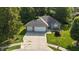 An aerial view of a home featuring a two-car garage, a spacious driveway, and a well-maintained yard at 1819 Quiet Haven Cir, Indianapolis, IN 46229