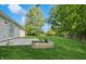 Expansive backyard with lush green grass, mature trees, and a concrete patio at 1819 Quiet Haven Cir, Indianapolis, IN 46229