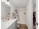 Modern bathroom featuring a double sink vanity, shower, and a view into the walk-in closet at 1819 Quiet Haven Cir, Indianapolis, IN 46229