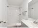 Clean bathroom featuring a shower with white tile, vanity with chrome faucet, and modern fixtures at 1819 Quiet Haven Cir, Indianapolis, IN 46229