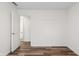 Bedroom with wood-look floors, neutral walls, and a door leading to another room at 1819 Quiet Haven Cir, Indianapolis, IN 46229