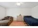 Bright bedroom with a lounger, neutral decor, natural light, and comfortable bed at 1819 Quiet Haven Cir, Indianapolis, IN 46229