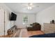 Comfortable bedroom with a lounge chair, ample natural light, and modern furnishings at 1819 Quiet Haven Cir, Indianapolis, IN 46229