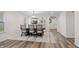 Bright dining area features hardwood floors, a modern dining table, and easy kitchen access at 1819 Quiet Haven Cir, Indianapolis, IN 46229