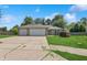 Home exterior with an attached two-car garage, spacious driveway, and a well-kept front yard at 1819 Quiet Haven Cir, Indianapolis, IN 46229