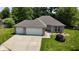 Charming single-story home with a two-car garage and well-maintained lawn at 1819 Quiet Haven Cir, Indianapolis, IN 46229