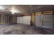 Spacious garage featuring three doors, concrete floor and exposed rafters at 1819 Quiet Haven Cir, Indianapolis, IN 46229