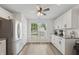 Bright kitchen featuring white cabinets, stainless steel appliances, and laminate flooring at 1819 Quiet Haven Cir, Indianapolis, IN 46229