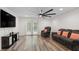 Spacious living room features plush seating, a large television, and sliding glass doors at 1819 Quiet Haven Cir, Indianapolis, IN 46229