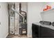 Utility room featuring washer, dryer, shelving, and mechanical equipment at 1819 Quiet Haven Cir, Indianapolis, IN 46229
