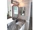 Well-lit bathroom featuring modern fixtures, granite countertop and decorative mirror at 18851 Wimbley Way, Noblesville, IN 46060