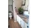 Bright bathroom featuring granite counters, white cabinets, and decorative plants at 18851 Wimbley Way, Noblesville, IN 46060