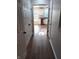 Hallway with wood flooring leads to a kitchen area with stainless steel dishwasher at 18851 Wimbley Way, Noblesville, IN 46060