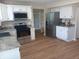 Modern kitchen with white cabinets, stainless steel appliances, and hardwood flooring at 18851 Wimbley Way, Noblesville, IN 46060