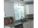 Well-lit kitchen featuring granite countertops, white cabinets, and modern fixtures at 18851 Wimbley Way, Noblesville, IN 46060