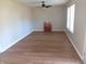 Spacious living room with hardwood floors, featuring natural light and a poppy painting accent at 18851 Wimbley Way, Noblesville, IN 46060