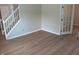 Living room with hardwood floors featuring white staircase and glass paneled doors at 18851 Wimbley Way, Noblesville, IN 46060
