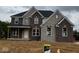 New two-story home featuring a brick and stone facade with a covered porch and large windows at 1919 Delp Ct, Avon, IN 46123