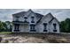 Two-story home with white exterior and black accents under construction, ready to be personalized with landscaping at 1919 Delp Ct, Avon, IN 46123