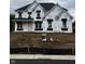 New two-story home construction with black roof, covered in Tyvek wrap and available sign at 1919 Delp Ct, Avon, IN 46123