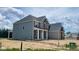 New two-story home featuring a mix of stone, siding, and brick exterior finishes, enhanced by an inviting covered front porch at 1919 Delp Ct, Avon, IN 46123