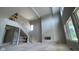 Bright and airy living room featuring high ceilings, large windows, a striking staircase, and fireplace at 1919 Delp Ct, Avon, IN 46123