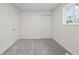 Bedroom with neutral paint, new carpet, two doors, and a bright window at 1948 Bloyd Ave, Indianapolis, IN 46218