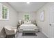 Inviting bedroom with a plush bed, neutral colors, and cozy reading chair at 1948 Bloyd Ave, Indianapolis, IN 46218