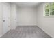 A bright bedroom features neutral paint, new carpet, and two white doors at 1948 Bloyd Ave, Indianapolis, IN 46218