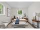 Relaxing bedroom with stylish decor, a plush bed, and a cozy seating area at 1948 Bloyd Ave, Indianapolis, IN 46218