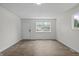 Bright living room showcasing hardwood floors, a large window, and fresh white paint at 1948 Bloyd Ave, Indianapolis, IN 46218