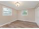 A bright bedroom with new flooring, fresh paint, two windows and closet for storage at 2925 E 8Th St, Anderson, IN 46012
