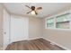 Neutral bedroom featuring wood-look flooring, ceiling fan, and closet at 2925 E 8Th St, Anderson, IN 46012