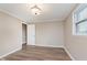 Bright bedroom featuring wood-look flooring, neutral paint, and a window providing natural light at 2925 E 8Th St, Anderson, IN 46012