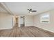 Open concept living room with new floors, neutral paint, and a ceiling fan at 2925 E 8Th St, Anderson, IN 46012