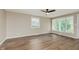Spacious living room featuring hardwood floors, a ceiling fan, and ample natural light at 2925 E 8Th St, Anderson, IN 46012