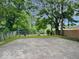 Backyard featuring a large concrete patio area, surrounded by mature trees and fencing for privacy at 3011 N New Jersey St, Indianapolis, IN 46205
