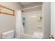 Bathroom featuring a combination tub and shower with white tiles, along with a comfortable toilet at 3011 N New Jersey St, Indianapolis, IN 46205