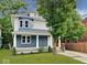 Charming two-story home with blue and white siding, a covered front porch, and well-maintained landscaping at 3011 N New Jersey St, Indianapolis, IN 46205