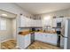 Modern kitchen with white cabinets, butcher block countertops, stainless steel appliances, and wood-look flooring at 3011 N New Jersey St, Indianapolis, IN 46205