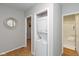 Hallway featuring a stackable washer and dryer unit with a decorative mirror at 3011 N New Jersey St, Indianapolis, IN 46205