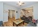 Open-concept living room with wood-look floors, neutral decor, and plenty of natural light and access to dining at 3011 N New Jersey St, Indianapolis, IN 46205