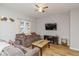 Cozy living room featuring wood-look floors, a ceiling fan, and comfortable seating arrangement with natural light at 3011 N New Jersey St, Indianapolis, IN 46205