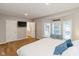 Primary bedroom with a bay window, TV, ensuite, and neutral decor, offering a comfortable retreat at 3011 N New Jersey St, Indianapolis, IN 46205