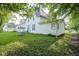 The backyard features lush green lawn, mature trees, and well maintained siding for Gathering enjoyment at 307 E 5Th St, Sheridan, IN 46069