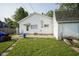 View of the backyard and shed, highlighting the lawn and exterior features at 307 E 5Th St, Sheridan, IN 46069