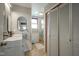 A well-lit bathroom with vanity sink, and a shower featuring tiled floors, is perfect for relaxation and comfort at 307 E 5Th St, Sheridan, IN 46069