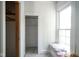 Bedroom featuring carpet, a closet, a built-in bench, paneled walls, and a window at 307 E 5Th St, Sheridan, IN 46069